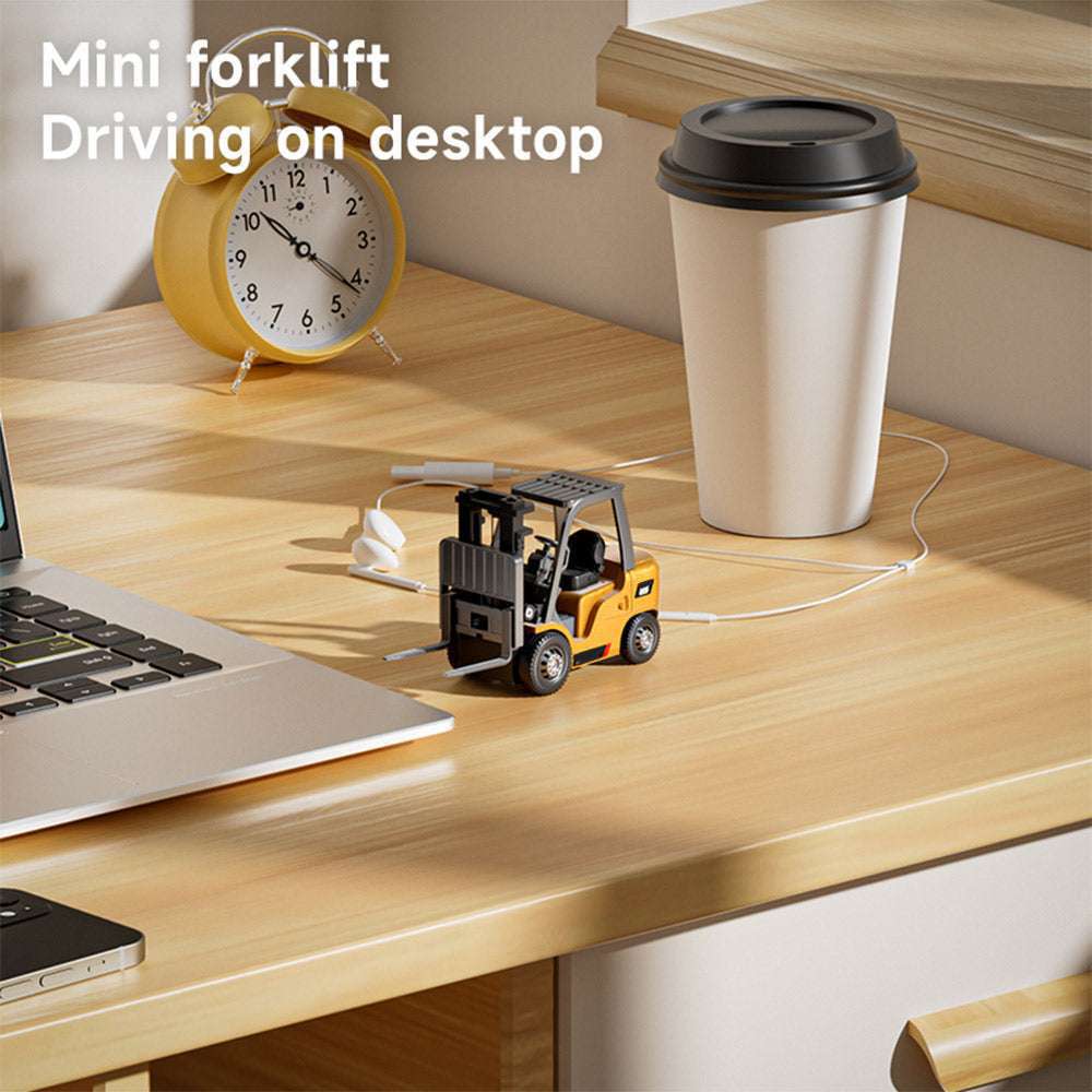 Mini forklift beside a laptop on a desktop