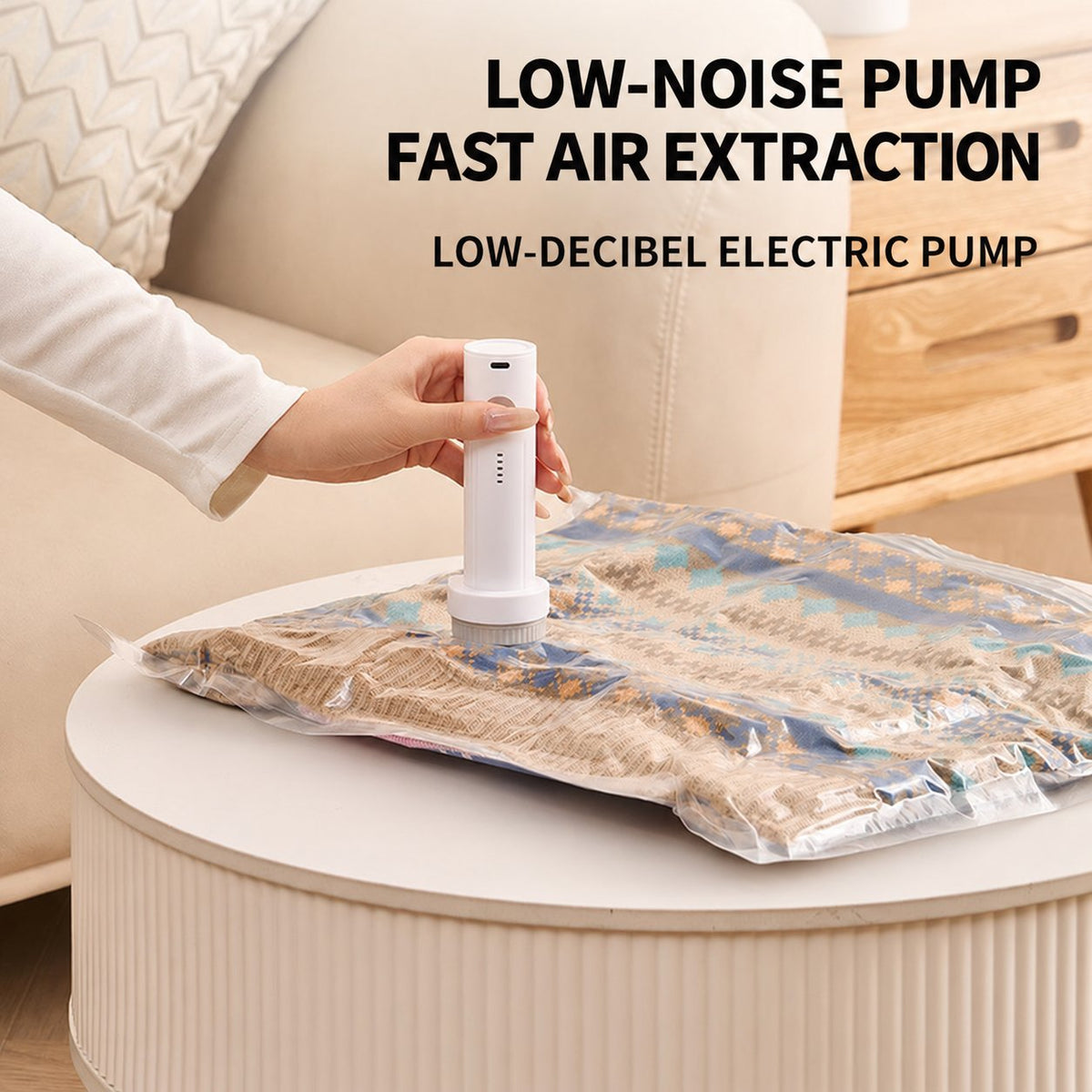 Cordless electric pump removing air from a vacuum storage bag filled with folded textiles