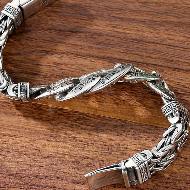 Close-up of Cuban links and braided chains on six-syllable mantra bracelet