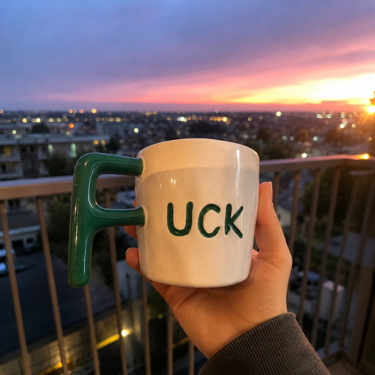 F Bomb mug held outdoors at sunset