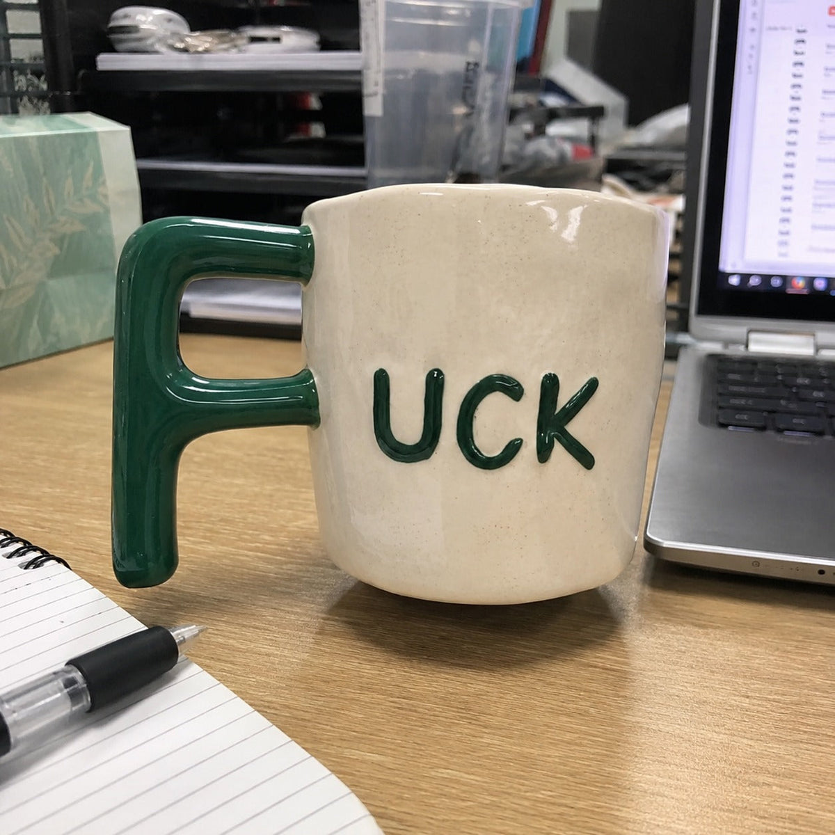 Close view of the green F-shaped mug handle