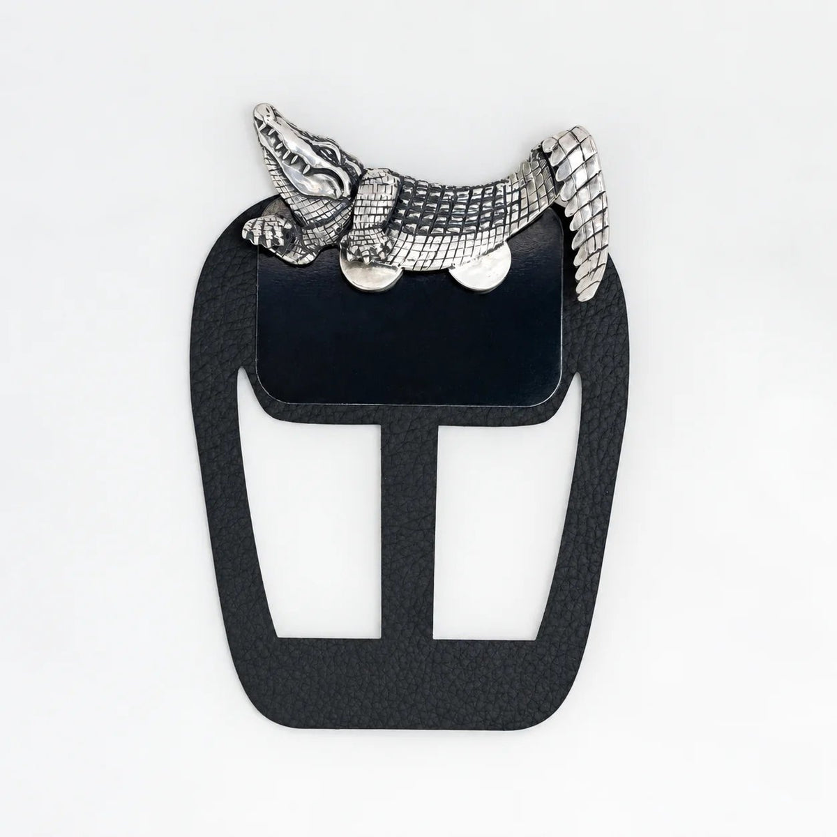 Sculpted alligator brooch styled on a tailored blue jacket