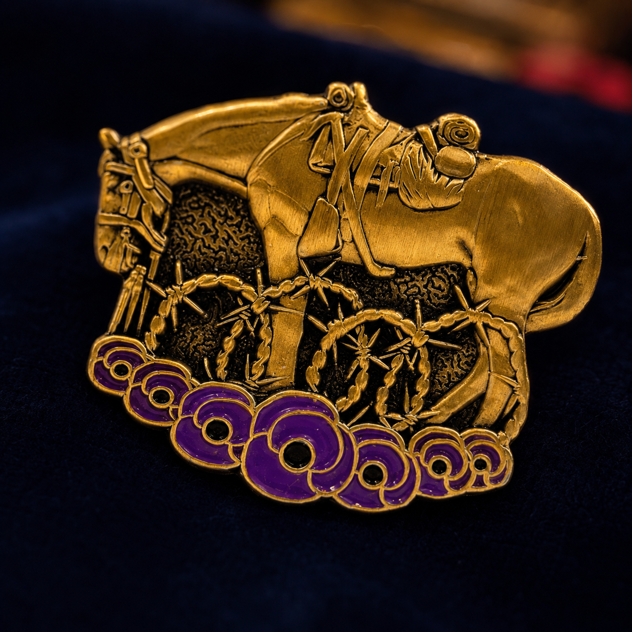 Close view of the antique gold war horse and purple poppy brooch